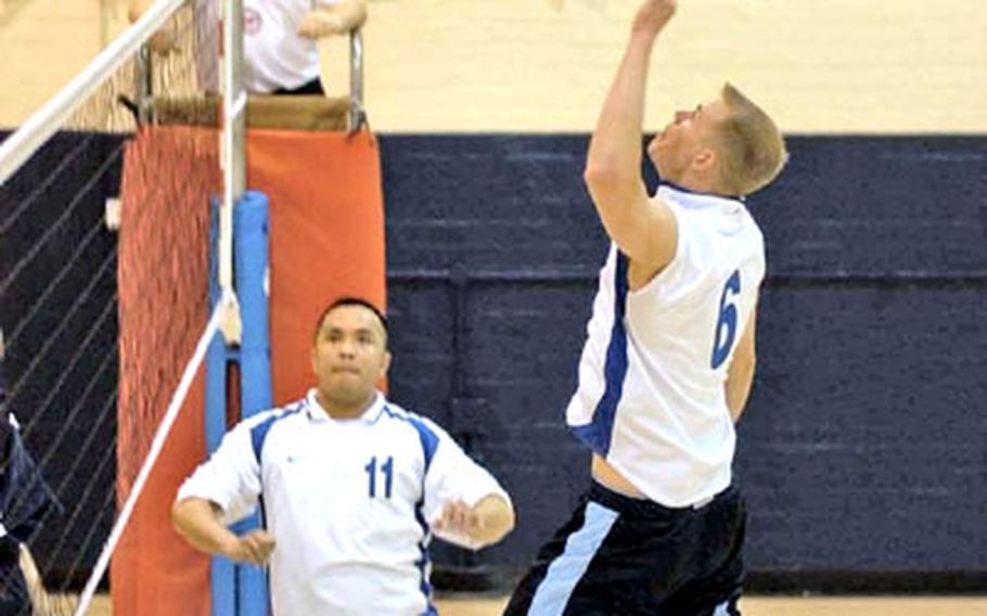 Lakenheath Eagles volleyball player Ryan Mozingo, foreground, goes airborne for a spike in the men’s finals of the USAFE volleyball championships against the Ramstein Rams on Friday at the Alconbury fitness center.