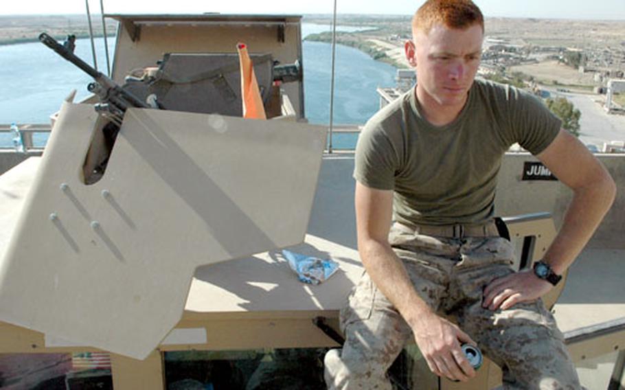 Lance Cpl. Samuel Smith of Greenville, S.C., pauses for a breakfast of pop tarts and soda before heading out on a daily patrol outside Haditha. “I couldn’t think of a better place to be to celebrate Memorial Day, over here fighting for what I believe in,” Smith said.