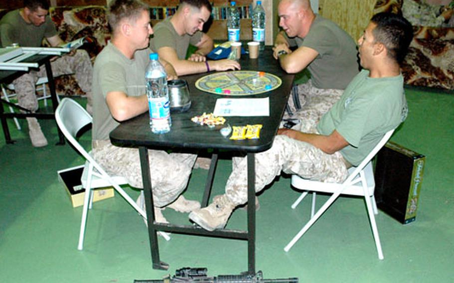 Several Marines find time Monday for a game of Trivial Pursuit, as life in Haditha continued like any other day.