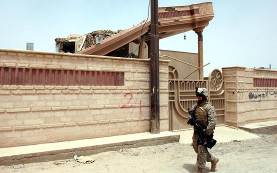 Lance Cpl. Vincent Gutilla, 20, from Fresno, Calif., patrols in the city of Husaybah, where there remains damage and markings from November, when the 2nd Battalion, 1st Marines pushed though in a house-by-house search. Husaybah has been largely quiet since the Marines pushed insurgents out six months ago and set up a series of patrol bases, but two recent suicide bombings show problems remain.