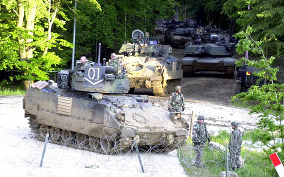 Tanks and Bradley Fighting Vehicles from Troop B, 1st Squadron, 1st Cavalry Regiment got stuck trying to breach this wire obstacle during exercises at Ubensdorf on Thursday after the lead vehicle was disabled by a rocket propelled grenade.