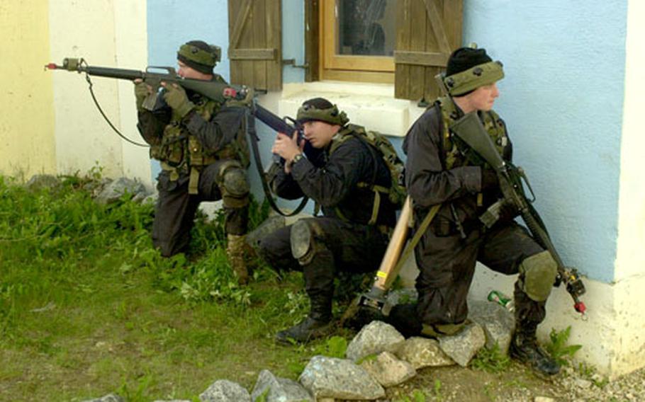 A team of Op For soldiers from 1st Battalion, 4th Infantry Regiment prepares to defend Ubensdorf from an attack by Troop B, 1st Squadron, 1st Cavalry Regiment during exercises on Thursday.