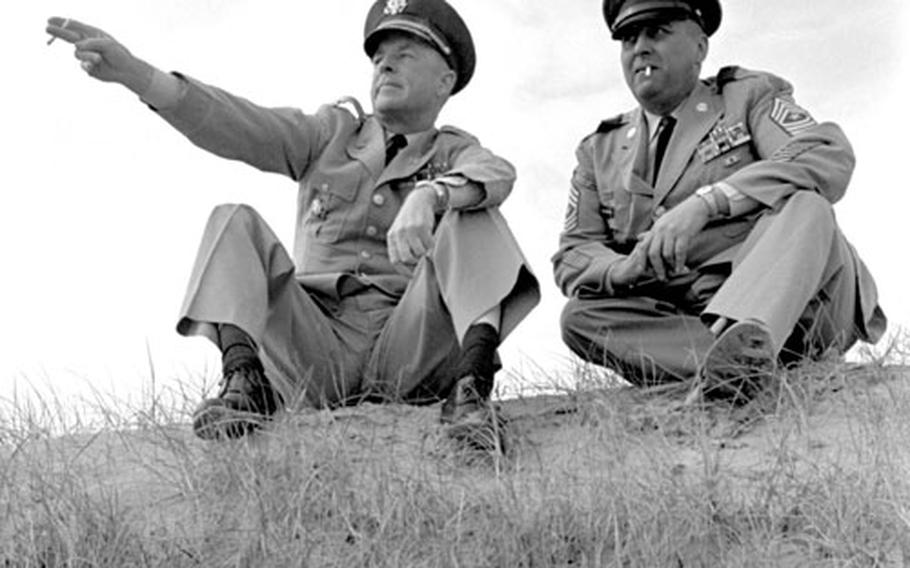 On a bluff overlooking Omaha Beach, Col. James K. Gaynor and Sgt. Maj. Jack Polnoroff talk about the invasion in which they participated 20 years earlier.