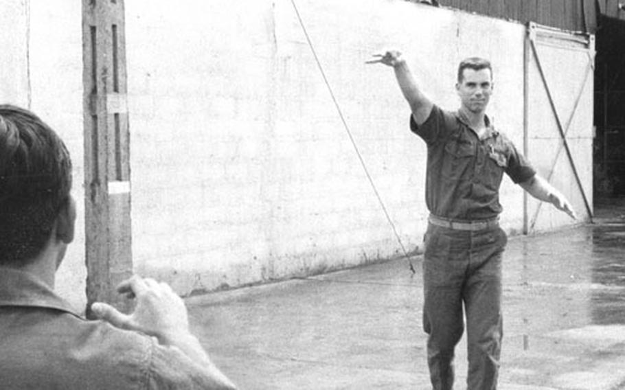 Ensign Roger Staubach tosses a football during a break from his duties at Da Nang in October, 1966.