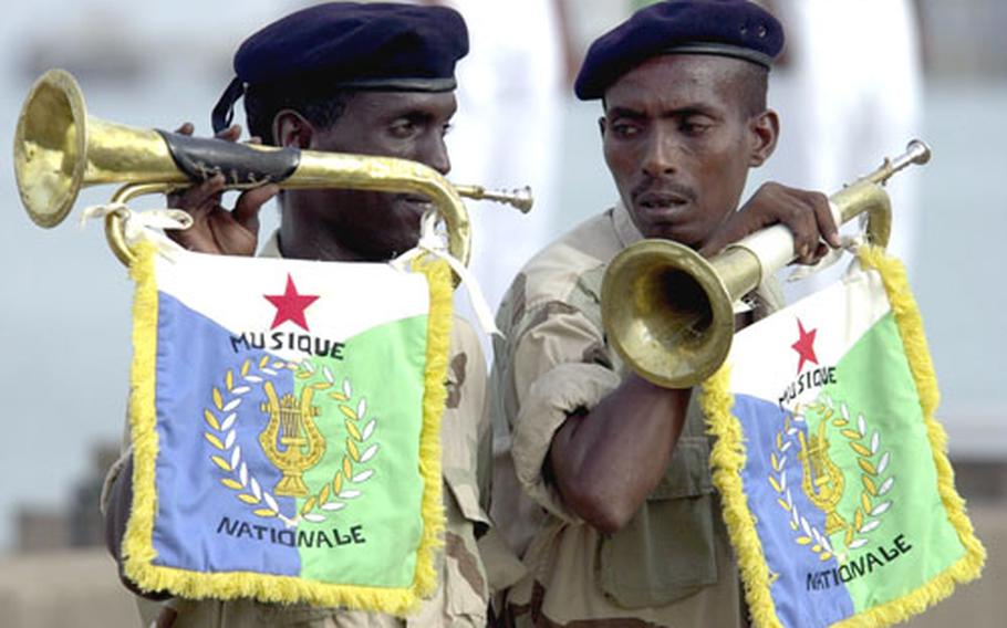 A pair of Djiboutian military buglers pause after playing a call-to-attention during Thursday morning&#39;s ceremony.