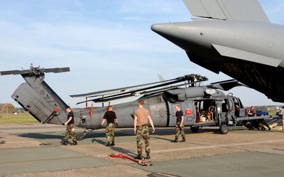 Airmen at RAF Lakenheath help unload a HH-60G helicopter delivered on a C-17 Monday. The aircraft and a small number of personnel are being reallocated to the England fighter base from Naval Air Station Keflavik, Iceland, this summer.