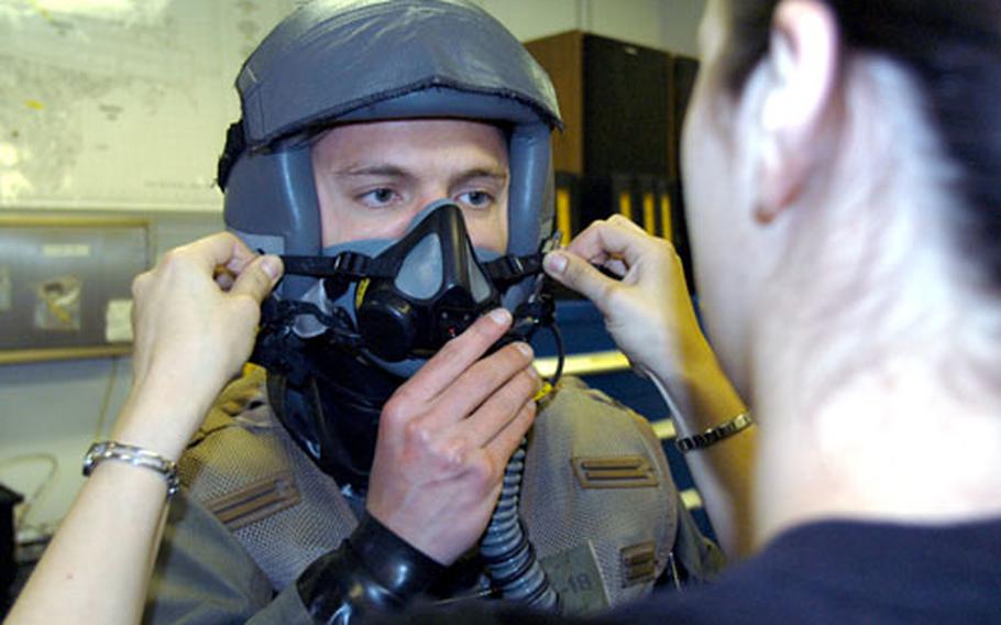 Scott Kumpula, a senior at the U.S. Air Force Academy, is fitted with a breathing mask Wednesday at Misawa Air Base, Japan, before his maiden ride on an F-16.