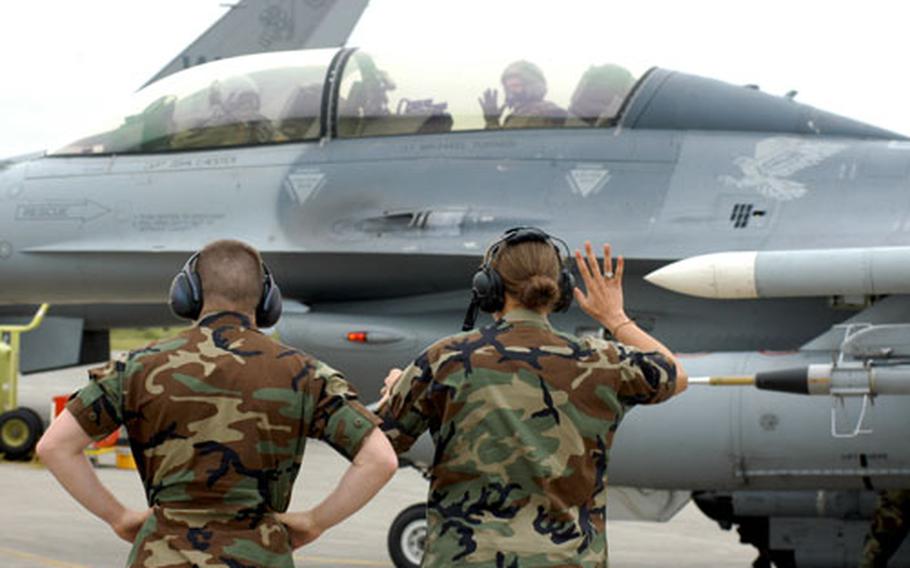 U.S. Air Force Academy senior Scott Kumpula waves to classmate Lindsay Freeman from the back seat of an F-16 at Misawa Air Base, Japan.