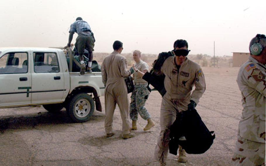 U.S. troops in Goa, Mali, hustle to transfer their gear from trucks to a waiting U.S. Air Force Special Operations C-130. The goal of a current joint operation with Mali is to train its military to secure its boarders and fight terrorism.