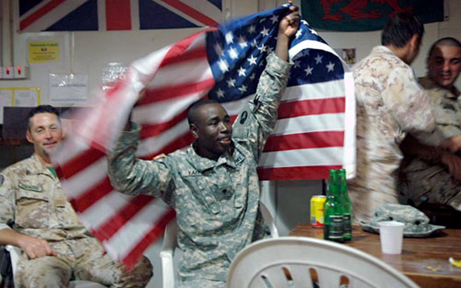 U.S. Army Spc. Ali Yaffa waves the Stars and Stripes after USA scores its one goal in the match against Italy. Italian soldiers are not subject to General Order No. 1, and therefore were allowed to drink alcohol, but Yaffa, who is Muslim, stuck to iced tea. The match, he said, was exciting enough.