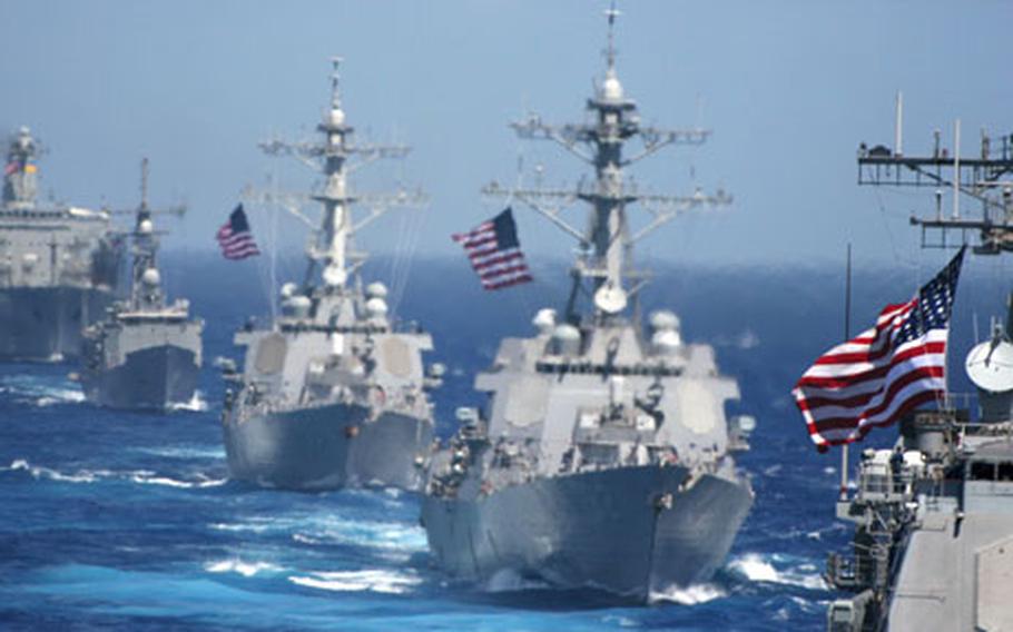 The USS Cowpens, foreground, is followed by the USS Lassen, USS John S. McCain, USS Vandegrift and USNS Tippecanoe during a photo exercise to kick off Exercise Valiant Shield 2006 in the Pacific Ocean on Sunday.