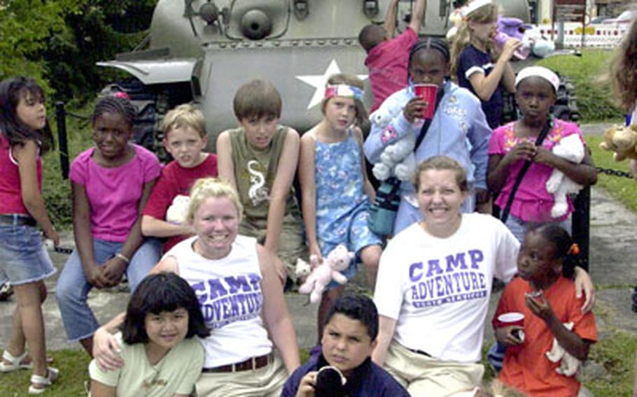 In Camp Adventure T-shirts: Counselors Krystie Daley, 20, of Davenport, Iowa, left, and Alison Keil, 18, of Toledo, Ohio, with children participating in the holiday program at Grafenwöhr, Germany, on Thursday.