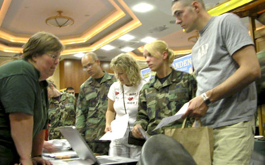Airman Michael Heim, right, and his wife, Airman Kathleen Heim, second from right, discuss German horseback riding excursions with Gabi Portz-Wagner, who runs some stables around Spangdahlem Air Base. The information was part of the air base&#39;s second annual "Explore the Eifel" event.