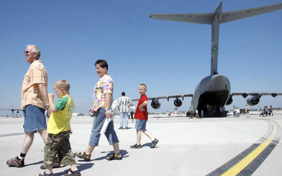 Members of the Thörnich family — Klaus, Timo, Linda and Nico — walk along the tarmac at Spangdahlem Air Base, Germany, during the base’s open house Saturday. They were excited to see the large planes, such as the C-17 behind them.