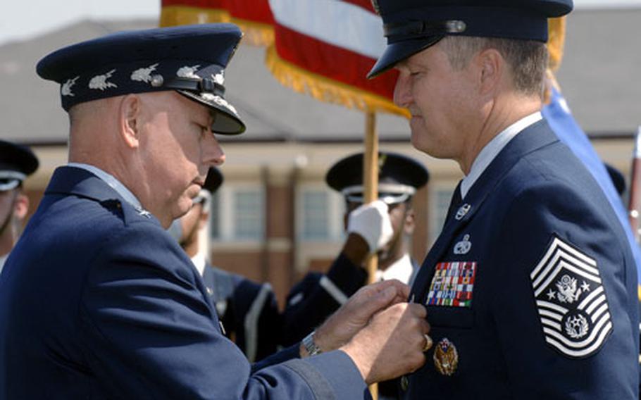 Gen. T. Michael Moseley, U.S. Air Force Chief of Staff, awards the Air Force Distinguished Service Medal to Chief Master Sgt. of the Air Force Gerald R. Murray, during Murray’s retirement ceremony June 30 at Bolling Air Force Base, Washington, D.C.