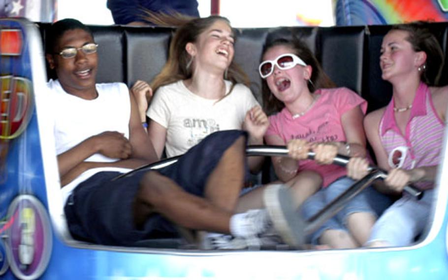 A group of teenagers get spun around in the "Waltzer" ride during the Fourth of July celebration at RAF Feltwell Monday.