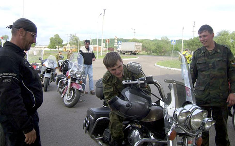 Russian soldiers check out U.S. Forces Korea civilian Robert Soska’s motorcycle.