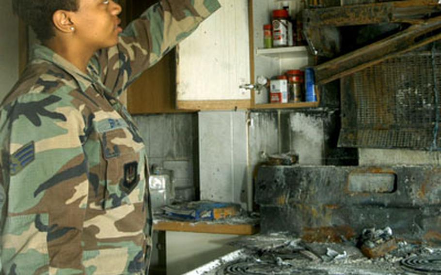 Bryant points to where the fire began. After the fire, she was overwhelmed with donations from local residents.