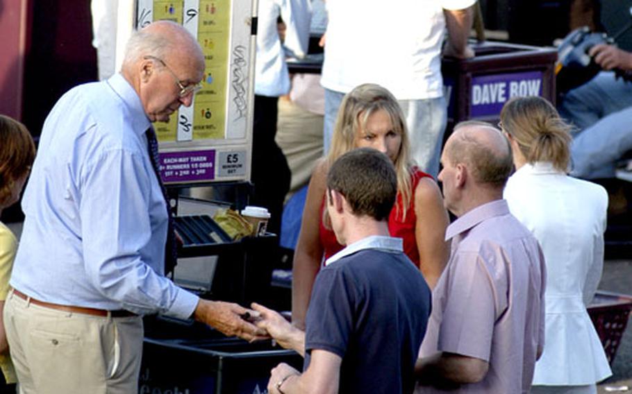Horse-racing fans place their bets.