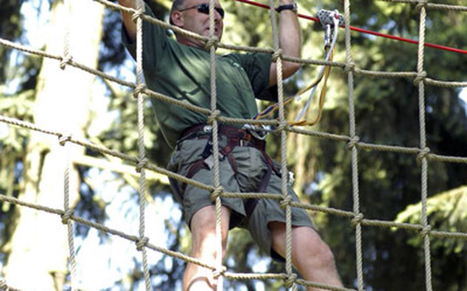 Chris Reynolds makes his way across the spider web obstacle.