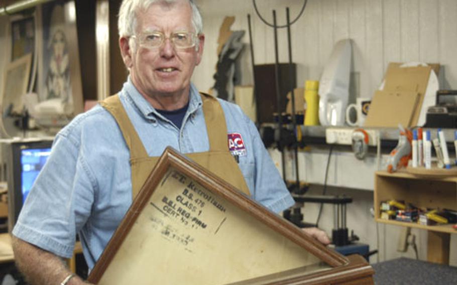 RAF Mildenhall framing shop craftsman and retired airman Jim Coleman shows one of his latest flag cases.