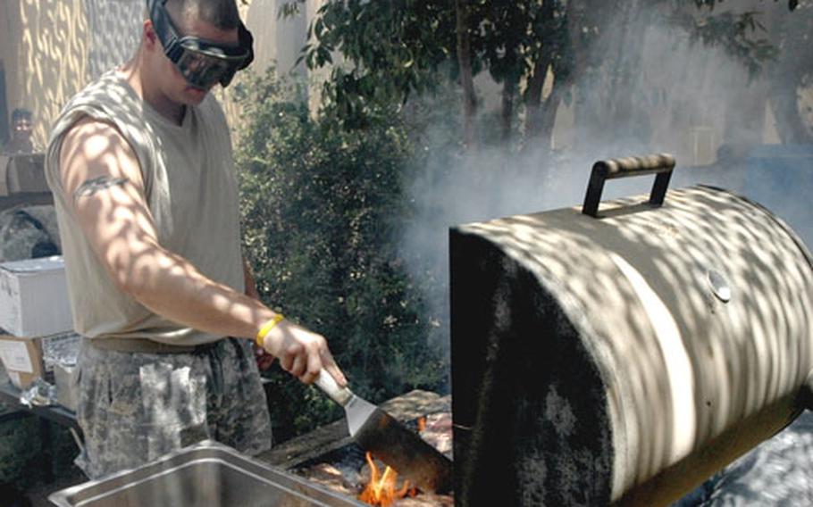 It&#39;s safety first as Sgt. Jonathan Hatcher, 26, of Cheraw, S.C. dons ballistic glasses to tend to the grill at a Fourth of July celebration at Forward Operating Base Paliwoda, Iraq. Troops from the 1st Battalion, 8th Infantry Regiment took part.