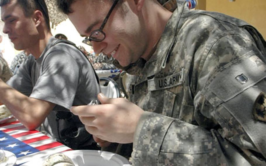 Pfc. Chase Collins, 20, of Dallas, digs into his ice cream at a Fourth of July celebration for 1st Battalion, 8th Infantry Regiment soldiers in Iraq.