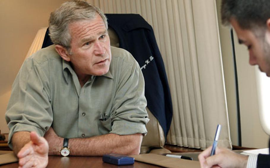 President Bush talks with Stripes reporter Jeff Schogol aboard Air Force One on Tuesday.
