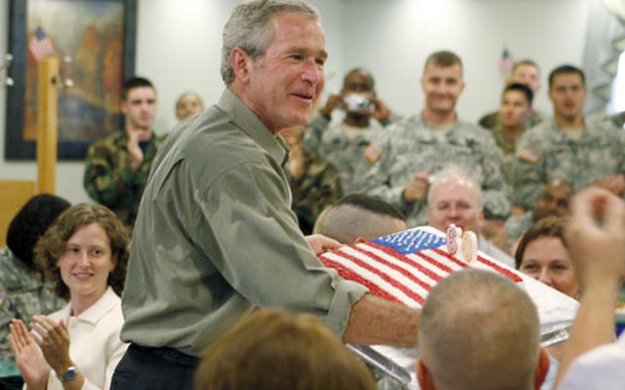 President Bush is presented with a cake in honor of his upcoming 60th birthday during a luncheon with troops Tuesday at Fort Bragg.