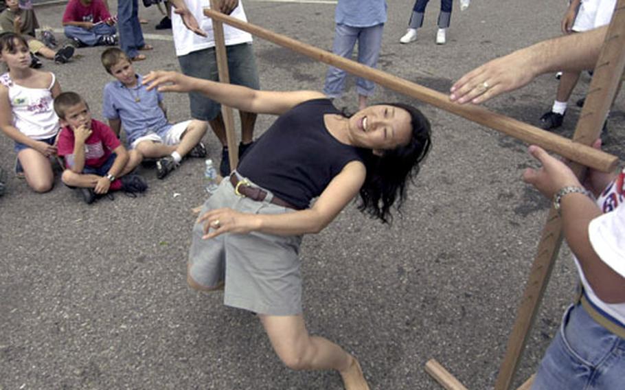 Ok-nan Clifton barely clears the limbo pole during a contest at the Fourth of July celebration on Yongsan Garrison, South Korea.