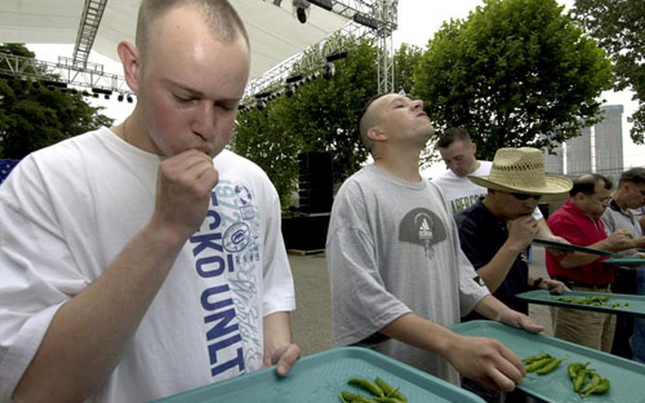 Spc. Michael Oman, of the 46th Transportation Company at Camp Stanley, works his way through a tray of 15 hot peppers during a contest at the Fourth of July celebration on Yongsan Garrison, South Korea.