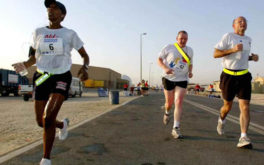 Three runners dash by during Tuesday’s Peachtree Roadrace 2006, sponsored by Atlanta Track Club and the Atlanta Journal-Constitution.
