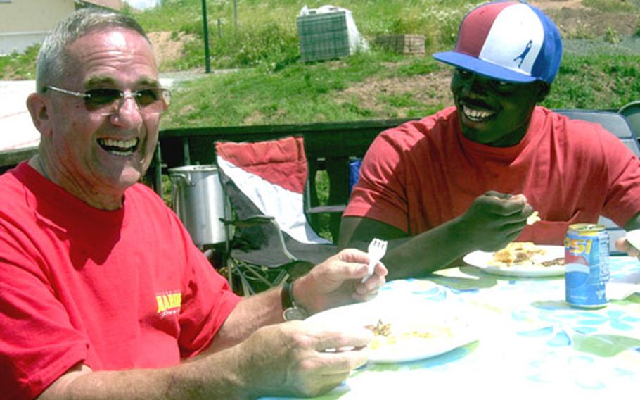 Truman Goodwin, left, an Air Force retiree and former Marine, shares a laugh with Marine Lance Cpl. Jose Martinez.