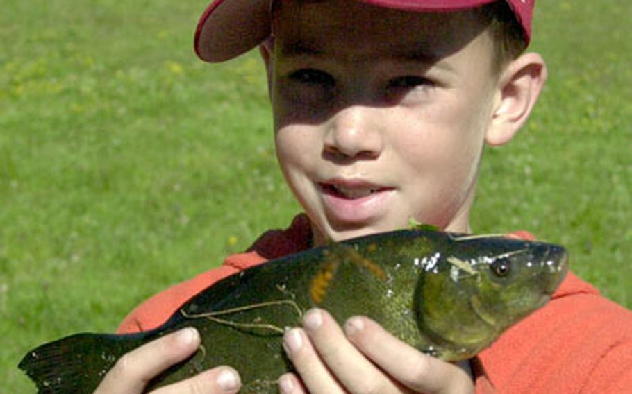 Grafenwöhr Elementary School student Nicholas Serrano, 9, proudly displays the Schleie he caught at the contest.