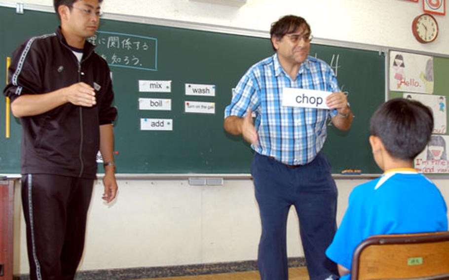 Larry Fine teaches fifth-graders Wednesday at Okamisawa Elementary School in Misawa city cooking terms such as “chop.” Fine is among seven assistant English teachers from Misawa Air Base, Japan, teaching English at Misawa city elementary schools this year as part of a new program to incorporate English into first to sixth grades.