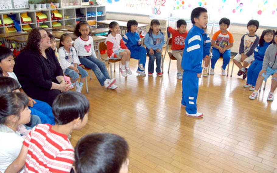 Trish Reams takes part in a game involving colors in English on Wednesday at Okamisawa Elementary School. Reams, a Navy spouse and civilian employee at Misawa Air Base, teaches English several times a month at the school.