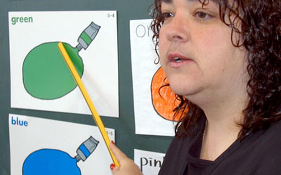 Trish Reams reviews colors in English on Wednesday at Okamisawa Elementary School.
