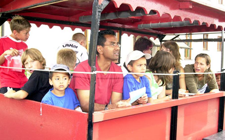 German and American children and adults take a train ride at a Youth 2 Youth kids’ festival in Sorghof, Germany, on Saturday.