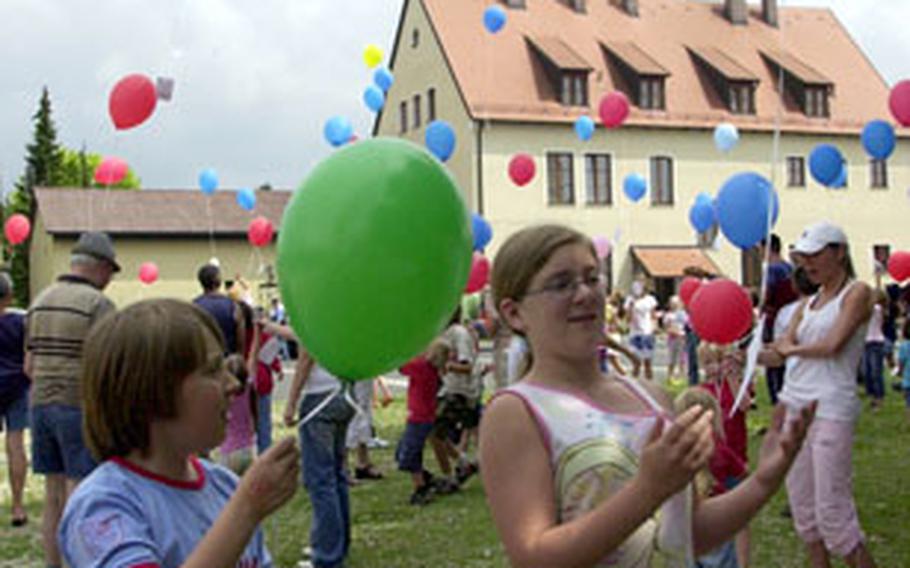 German schoolgirls Verena Schmidt, left, 10, and Smantha Smith, 12, release balloons at a Youth 2 Youth kids’ festival in Sorghof, Germany, on Saturday.