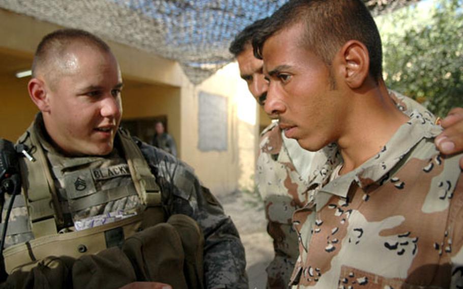 Staff Sgt. Cory Blackwell, left, of 1st Battalion, 8th Infantry Division’s Company B, briefs Iraqi privates Hasien Rashid, 30, center, and Ali Asi, 21. Both Iraqi soldiers are members of the 3rd Battalion’s 4th Company, also known as the “Tiger Company.”