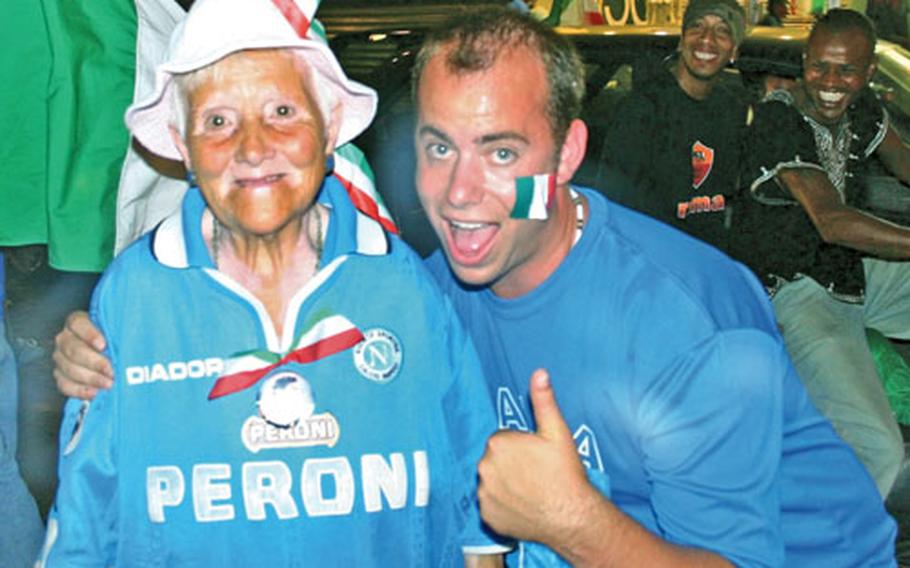 American sailor Shaun Knittel poses with an unidentified elderly Italian woman amid the chaos and pandemonium on the streets of Naples, Italy, on Sunday.