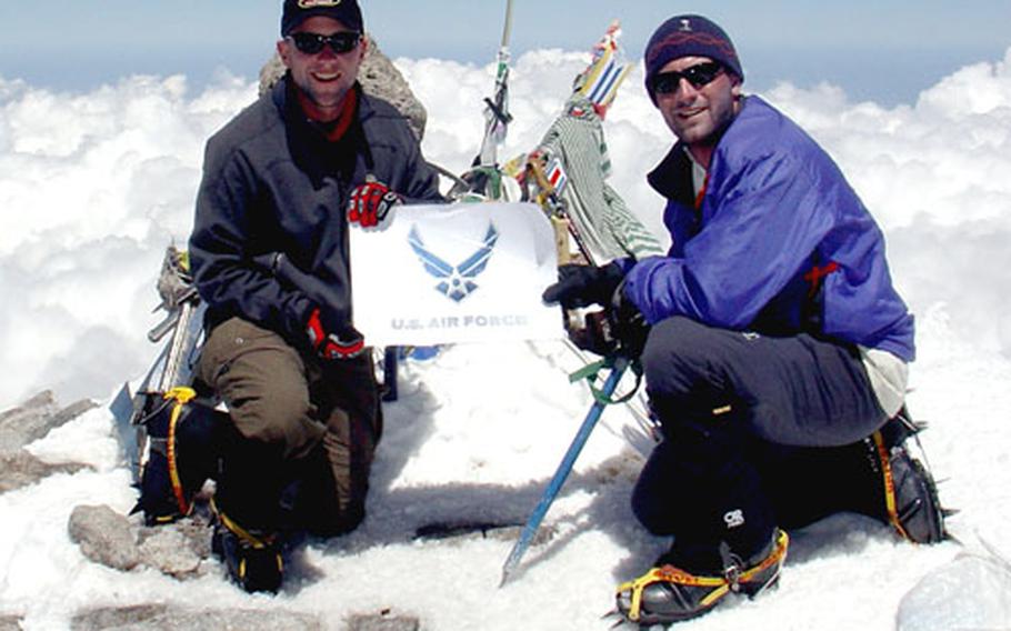Capt. Rob Marshall, left, and 1st. Lt. Mark Uberuaga hold up the Air Force logo at the summit of 18,512-foot Mt. Elbrus in Russia, the highest point on the European continent.