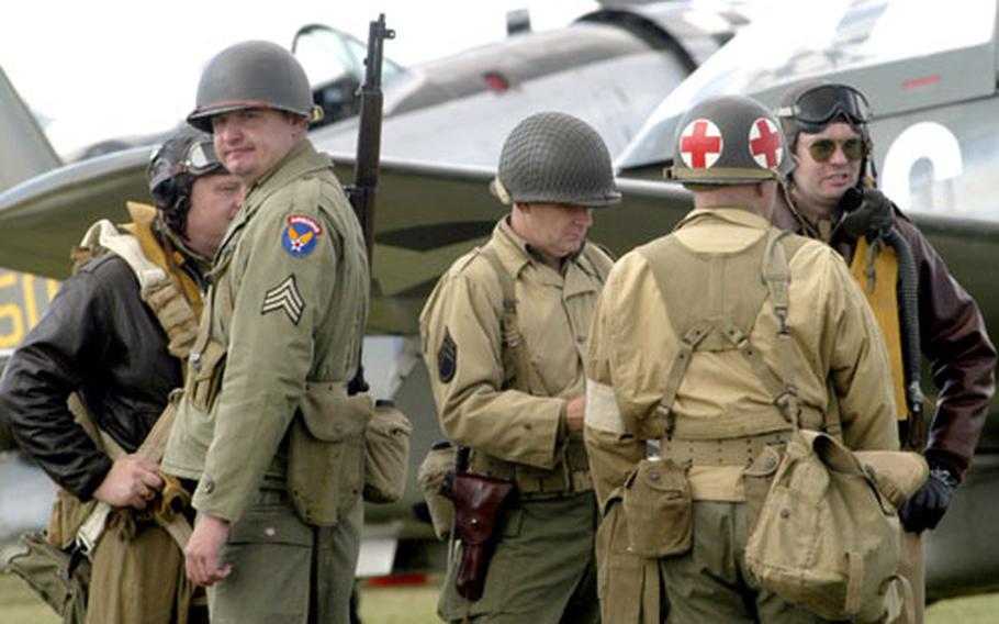 A group of men dressed as a World War II flying crew gather on the grounds of the Imperial War Museum Duxford during last weekend’s Flying Legends Air Show.