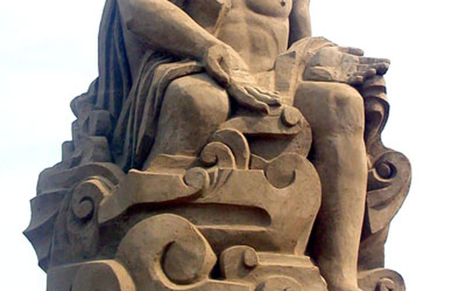 Zeus, erected from sand and water, sits above his kingdom at the festival.
