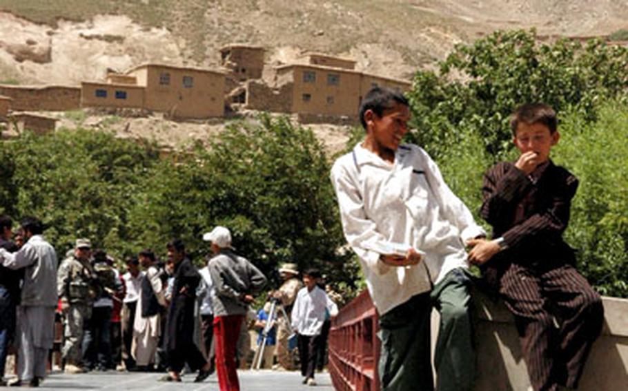 Two friends play at the edge of the newly finished bridge outside Nawaj, Afghanistan, on Tuesday.