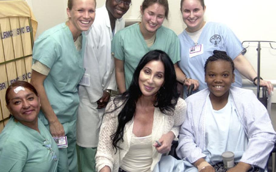 Cher stops to pose for a photo in a hallway at Landstuhl Regional Medical Center on Wednesday. She spent hours visiting wounded troops and thanking staff at the largest American hospital outside the U.S., and plans to visit other areas in the Kaiserslautern military community on Thursday.