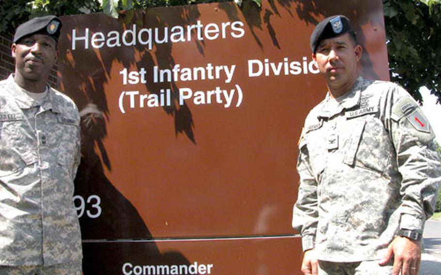 Sgt. Maj. Michael Burrell, left, and Col. Benjamin Everson, are among the few remaining members of the 1st Infantry Division at Leighton Barracks in Würzburg, Germany. With most of the division relocating to the States, Burrell and Everson head up a 1st ID trail party that will stay at Leighton until December. They&#39;ve even been given a permanent-looking temporary sign.
