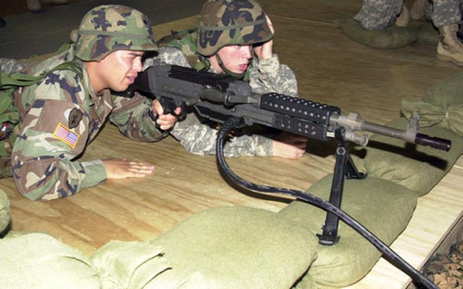Spc. Gabriel Martinez, 24, of Fresno, Calif., left, and Spc. Christopher Taylor, 21, of Green Bay, Wis., fire an M-249 machine gun at Vilseck’s Warrior Marksmanship Training Facility on Wednesday.