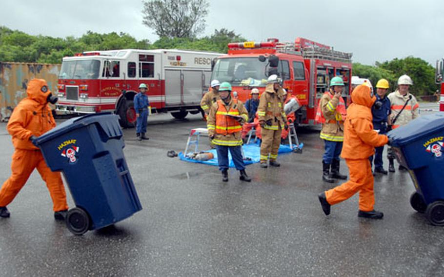 Emergency responders from the 18th Civil Engineer Squadron and Nirai Fire Department clean and contain “hazardous” materials during a joint training exercise at Kadena Air Base on Friday.