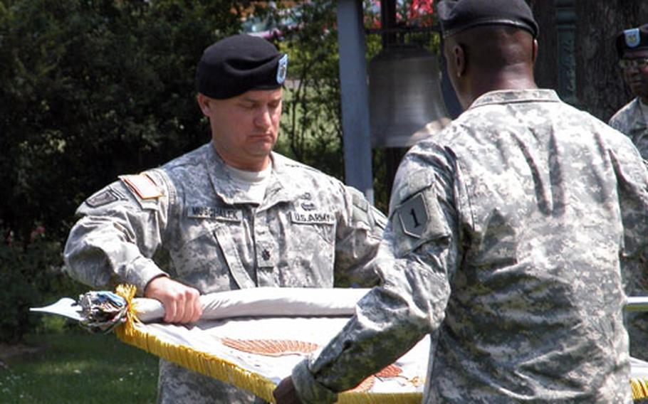 Lt. Col. Keith Muschalek, center, and 1st Sgt. Christopher Cosby case the colors of the 106th Finance Battalion during a ceremony Friday at Victory Park on Leighton Barracks in Würzburg, Germany.